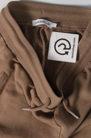Детско спортно долнище Calvin Klein Jeans, Размер 12-13y/ 158-164 см, Цвят Бежов, Цена 108,42 лв.