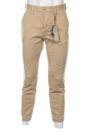 Męskie spodnie Tommy Jeans, Rozmiar S, Kolor Beżowy, Cena 423,99 zł