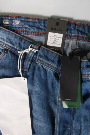 Męskie jeansy G-Star Raw, Rozmiar M, Kolor Niebieski, Cena 299,06 zł