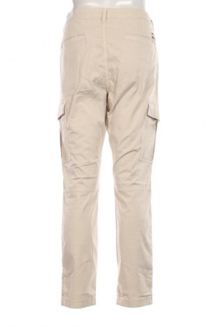 Męskie spodnie Tommy Jeans, Rozmiar M, Kolor Beżowy, Cena 604,99 zł